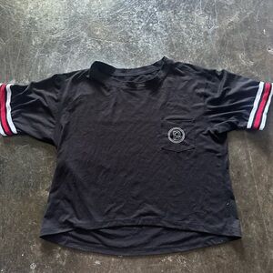 Pure Barre cropped top with stripe sleeve detail.